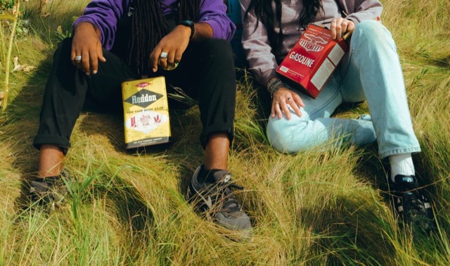 Hands, vintage tins and denim in the grass at the Gas Station shoot.