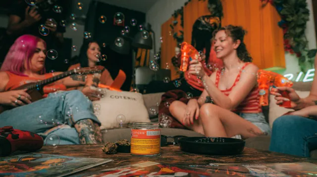 Friends relaxing together on a sofa in a colourful campaign set.